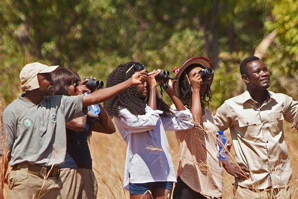 Image of tourists enjoying a guided walk at Zaina Lodge, Mole National Park, Ghana
