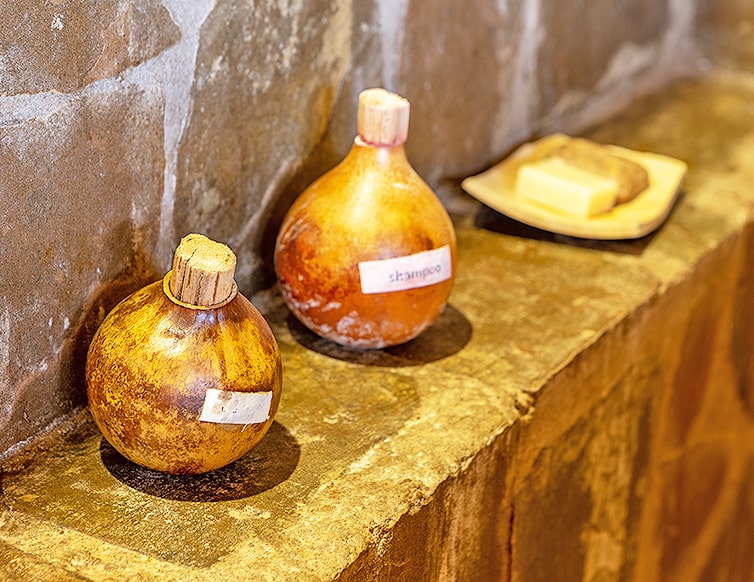 Image of the calabash bottles containing shea butter bodywash and shampoo at the chalets in Zaina Lodge, Mole National Park, Ghana