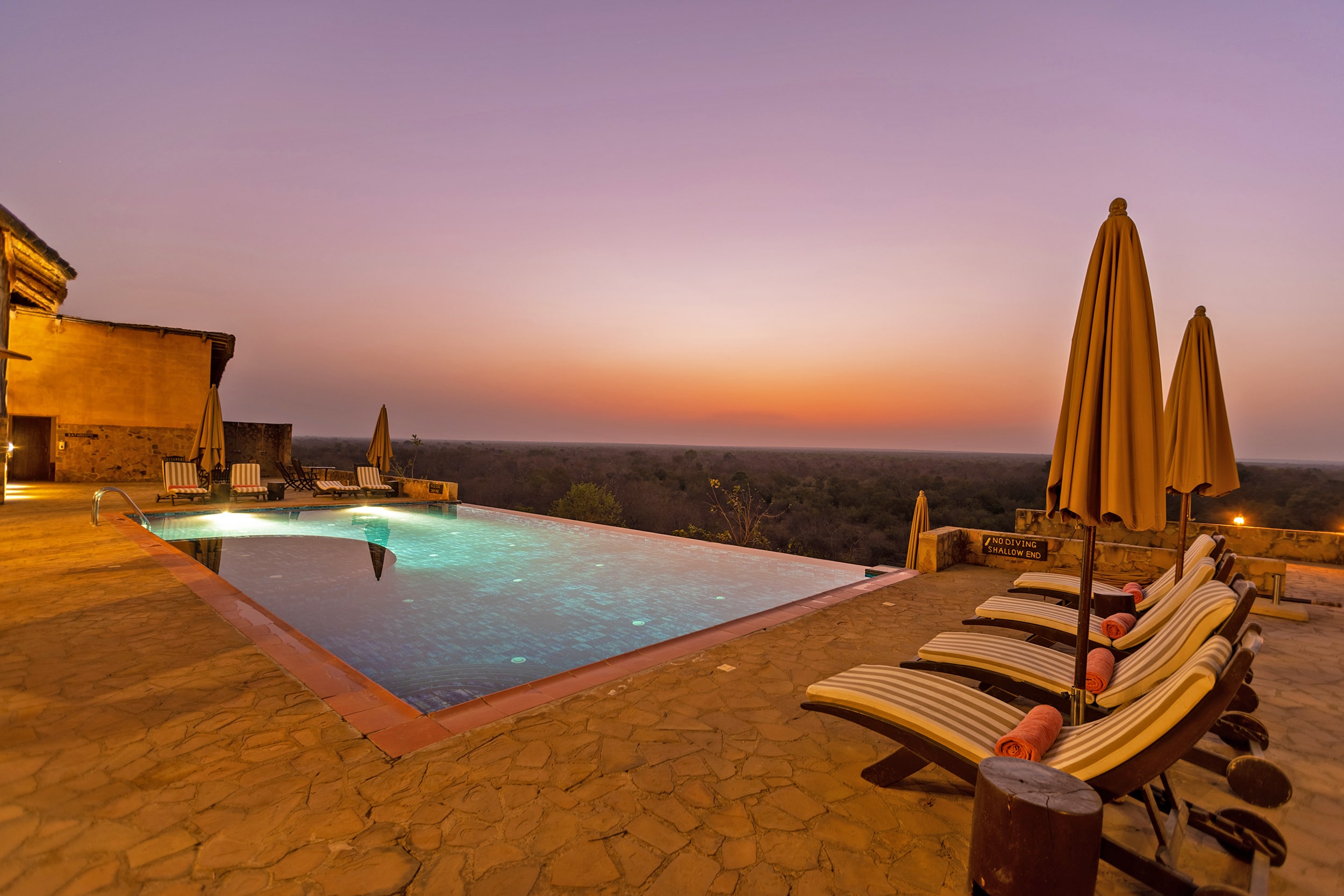 Image of the vibrant colours of dusk from the infinity pool at Zaina Lodge, Mole National Park, Ghana